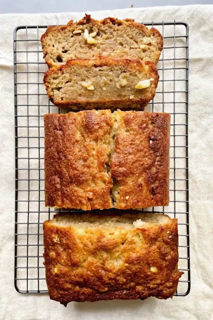 Freshly baked sliced cottage cheese banana bread cooling on a wire rack