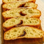 Sliced cinnamon roll focaccia sourdough with visible cinnamon swirls and airy crumb