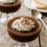 Coffee Budino: The Silky, Make-Ahead Dessert You Need to Try 5 Silky coffee budino in elegant glass cups, crowned with fluffy whipped cream and a dusting of cocoa — rich, smooth, and ready to indulge.