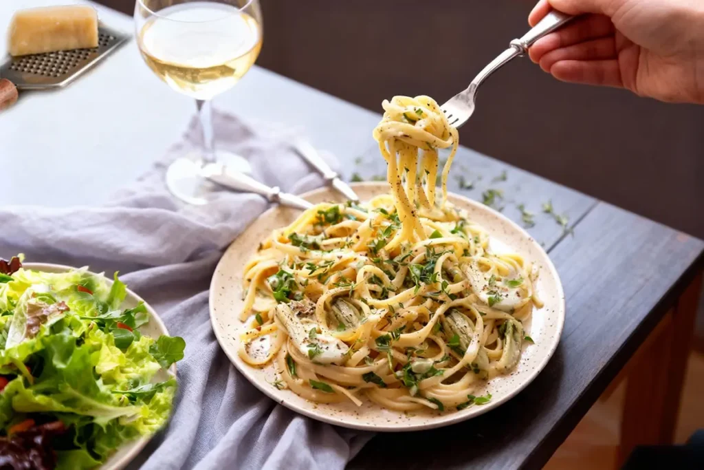 Canned Artichoke Hearts: The Ultimate Guide (Recipes, Nutrition & Cooking Tips) 7 Creamy pasta with canned artichoke hearts served with fresh herbs