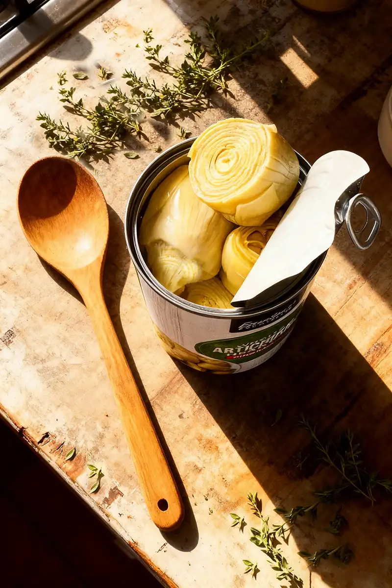 Canned Artichoke Hearts: The Ultimate Guide (Recipes, Nutrition & Cooking Tips) 4 Canned artichoke hearts on rustic counter