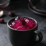A split-screen diptych of raw grass-fed beef gelatin ingredients (left) next to a dark mug of vibrant, hibiscus-colored gelatin (right) for the Dr. Mark method.