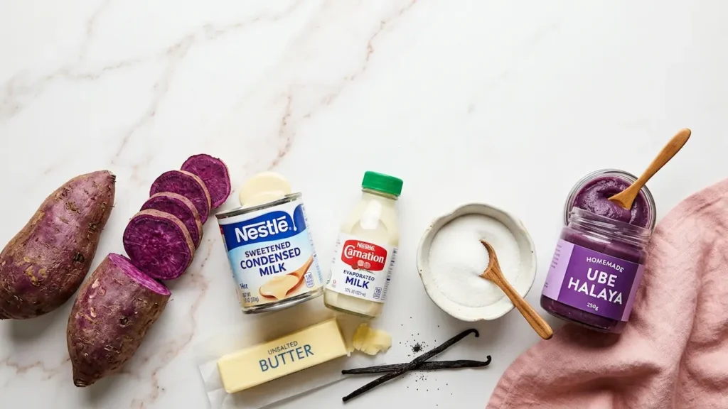 Ube Halaya Recipe: 3 Ways to Make Authentic Purple Yam Jam. 11 Ube halaya ingredients flat lay: fresh purple yam, condensed milk, evaporated milk, sugar, butter, and vanilla on marble.
