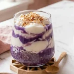 Ube taho recipe: layered Filipino purple dessert with silken tofu, tapioca pearls, and toasted coconut in a glass.